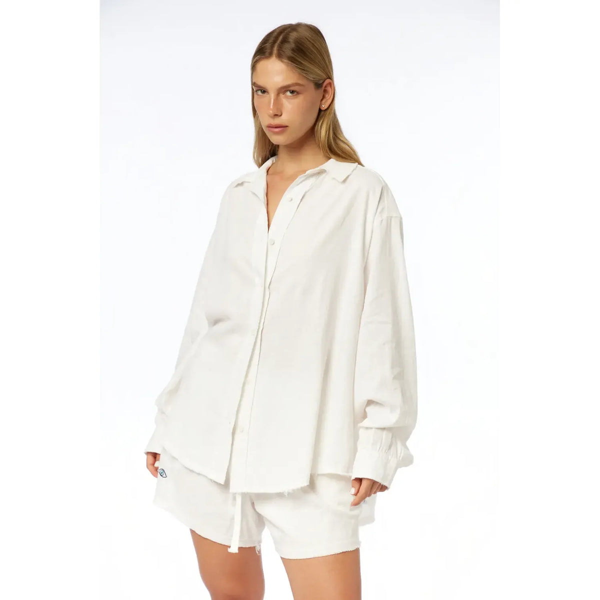 Woman wearing white Pure Linen Women's Shorts and a matching oversized white linen shirt
