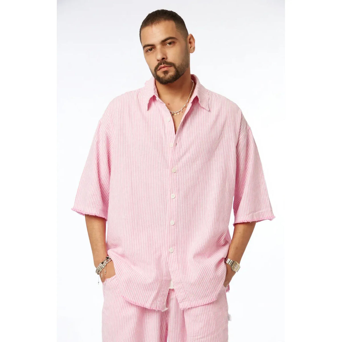 Man wearing a pink striped linen short sleeve button-up shirt