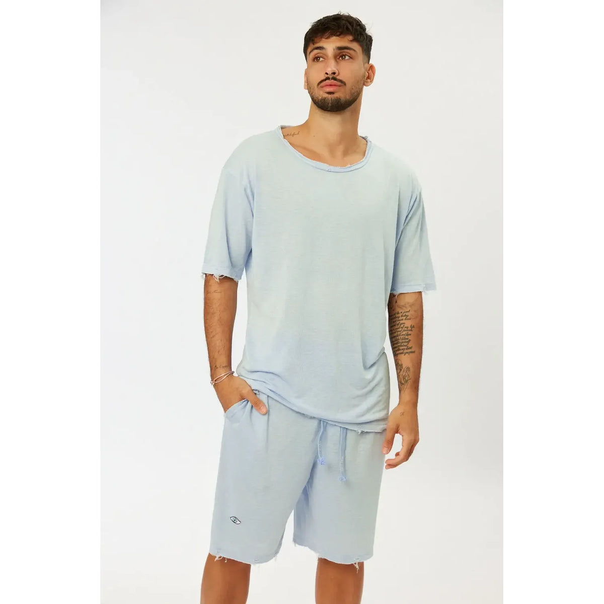 Man wearing light blue BASE Shorts and matching t-shirt
