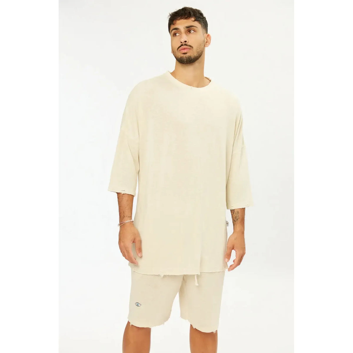 Man wearing Base Shorts in stone, with a matching oversized t-shirt