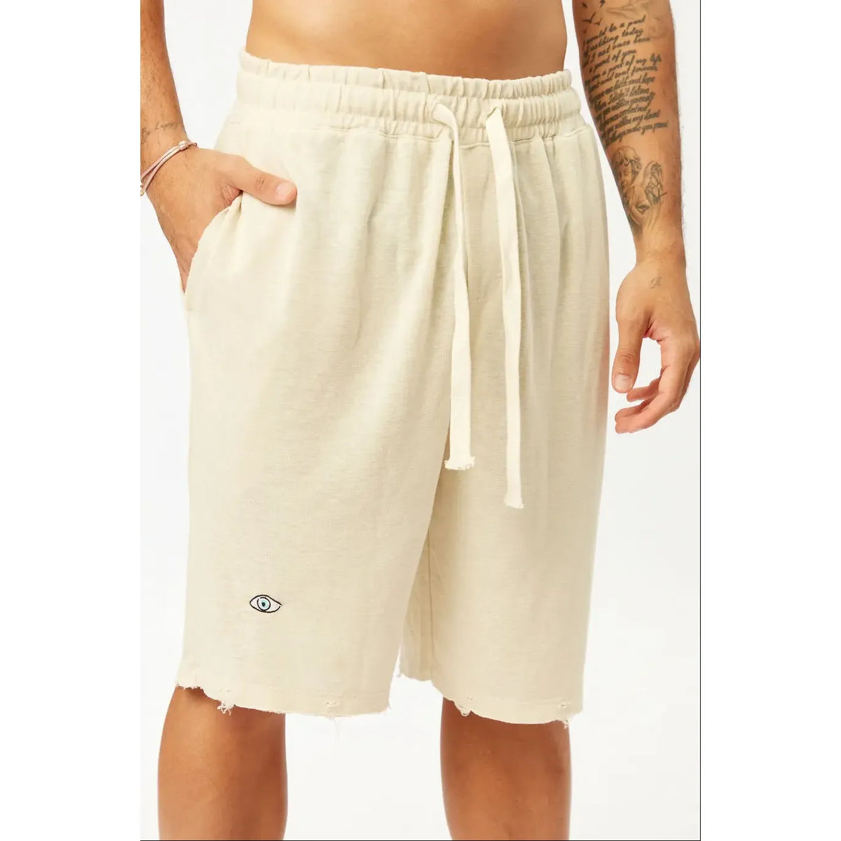 Base Shorts in Stone with an eye graphic and distressed hem