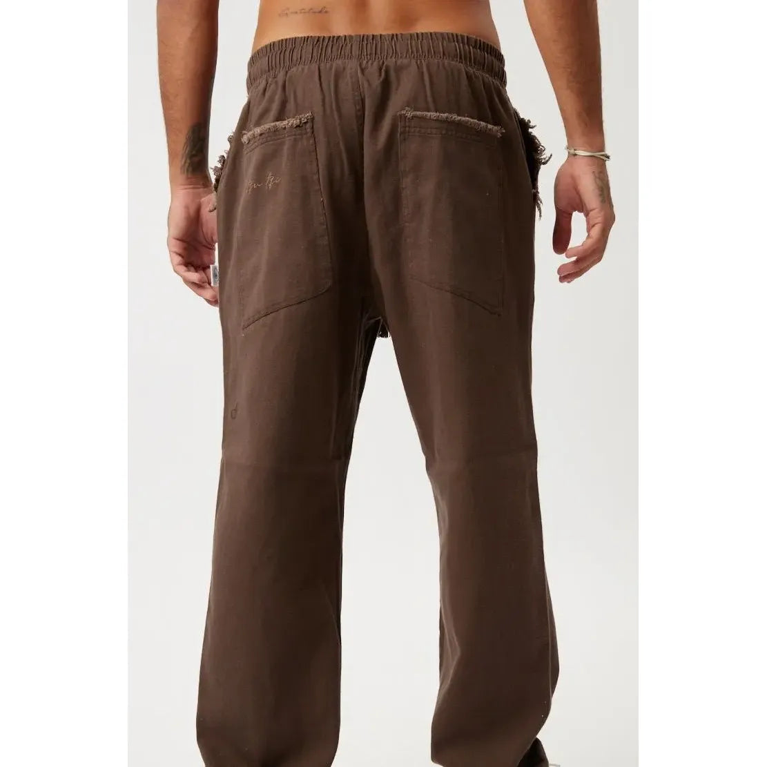 Back view of brown DC SL Pants with an elasticated waist and distressed pockets