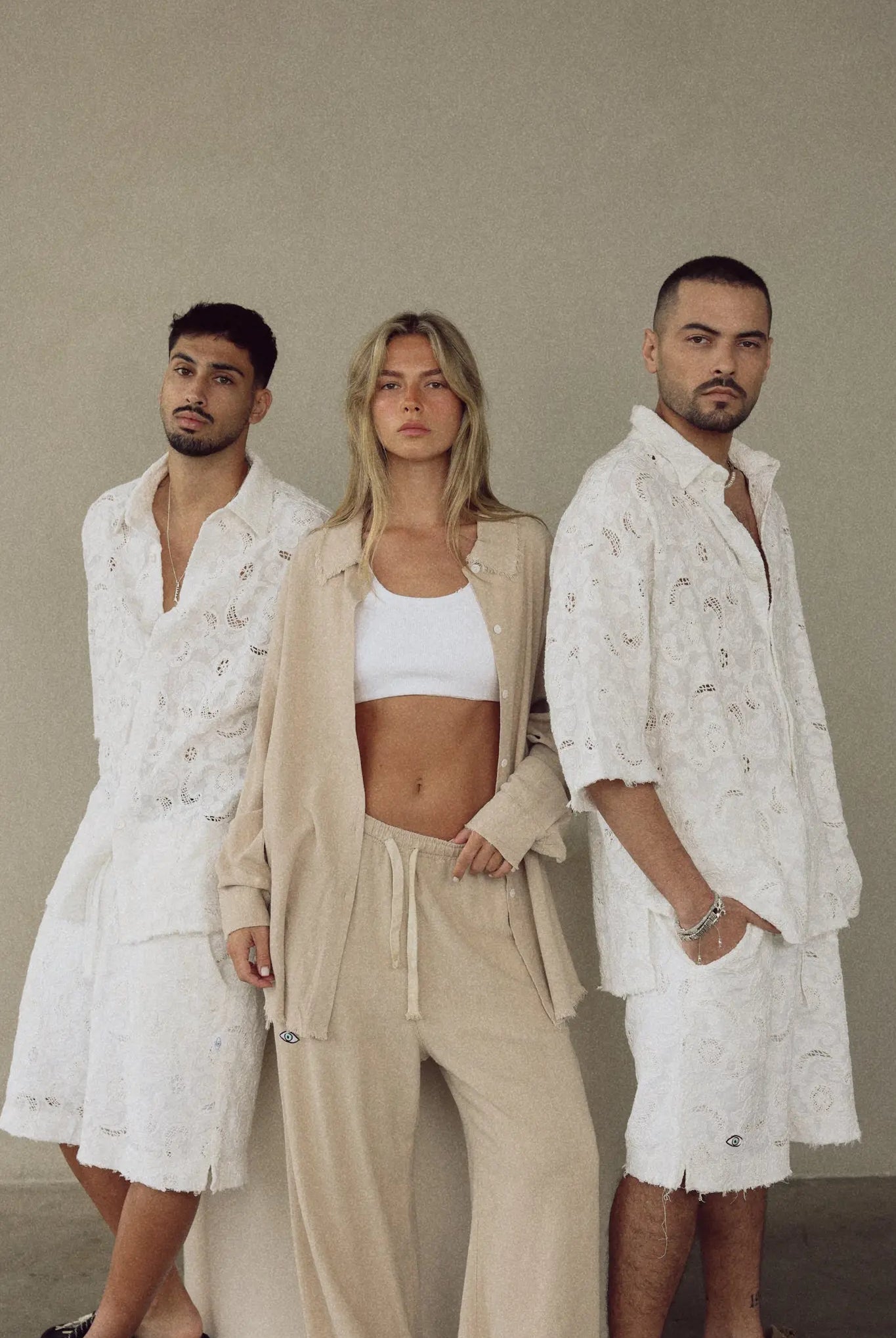 Three models wearing FLR WHITE LIMITED EDITION Jacket and matching shorts and pants