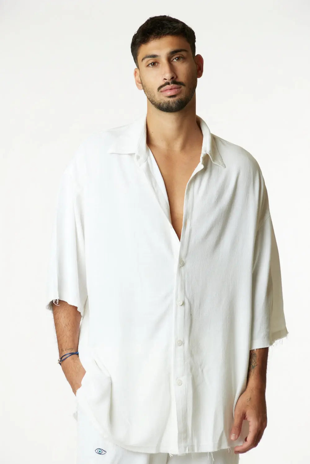 Man wearing a cream Soft Linen Short Sleeve Button-Up Shirt