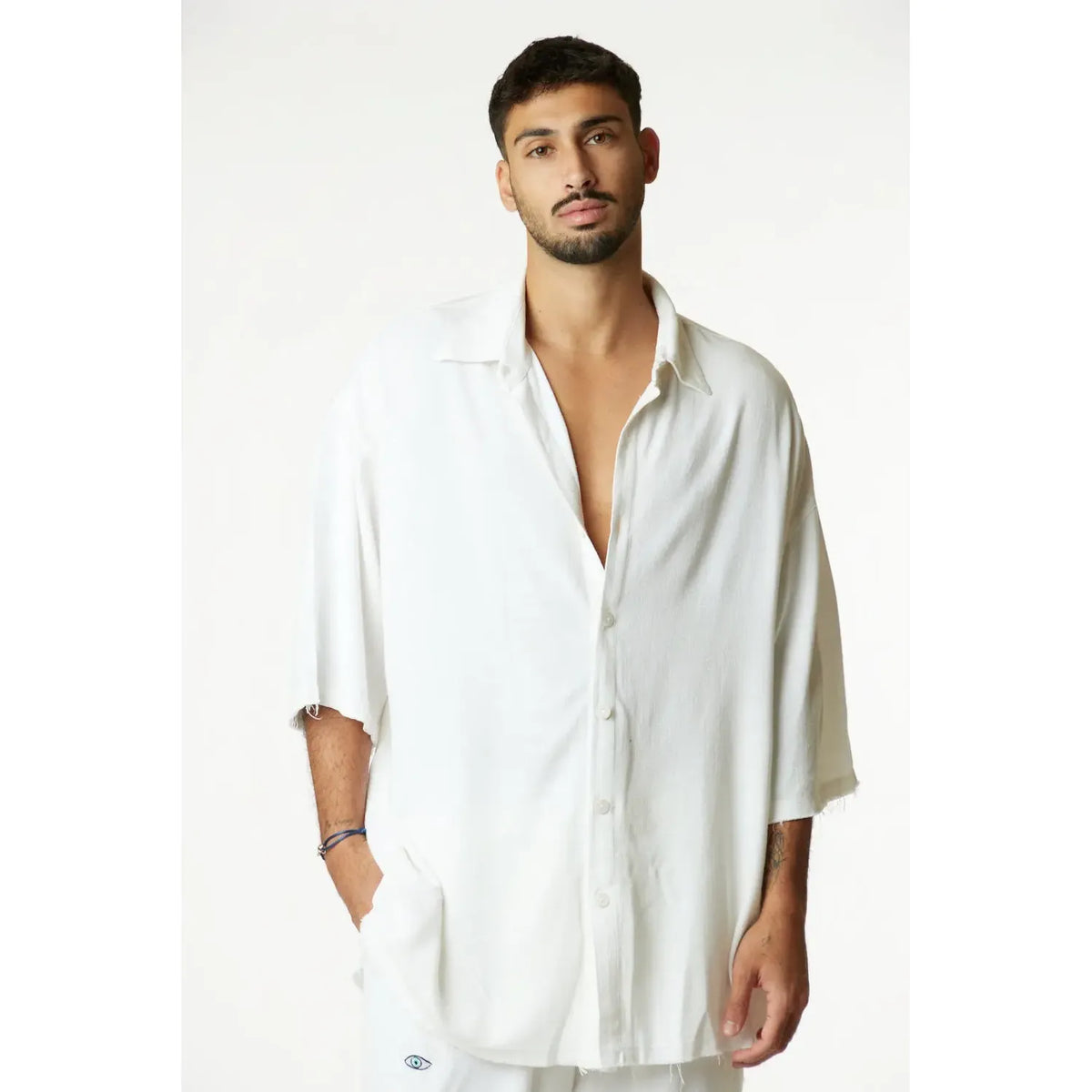 Man wearing a cream Soft Linen Short Sleeve Button-Up Shirt