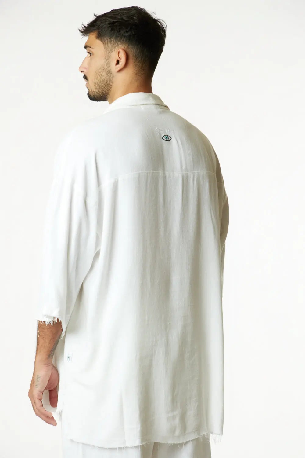 Soft Linen Short Sleeve Button-Up Shirt in Cream, back view with embroidered eye detail on the upper back