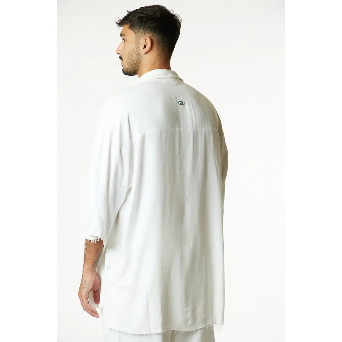 Soft Linen Short Sleeve Button-Up Shirt in Cream, back view with embroidered eye detail on the upper back