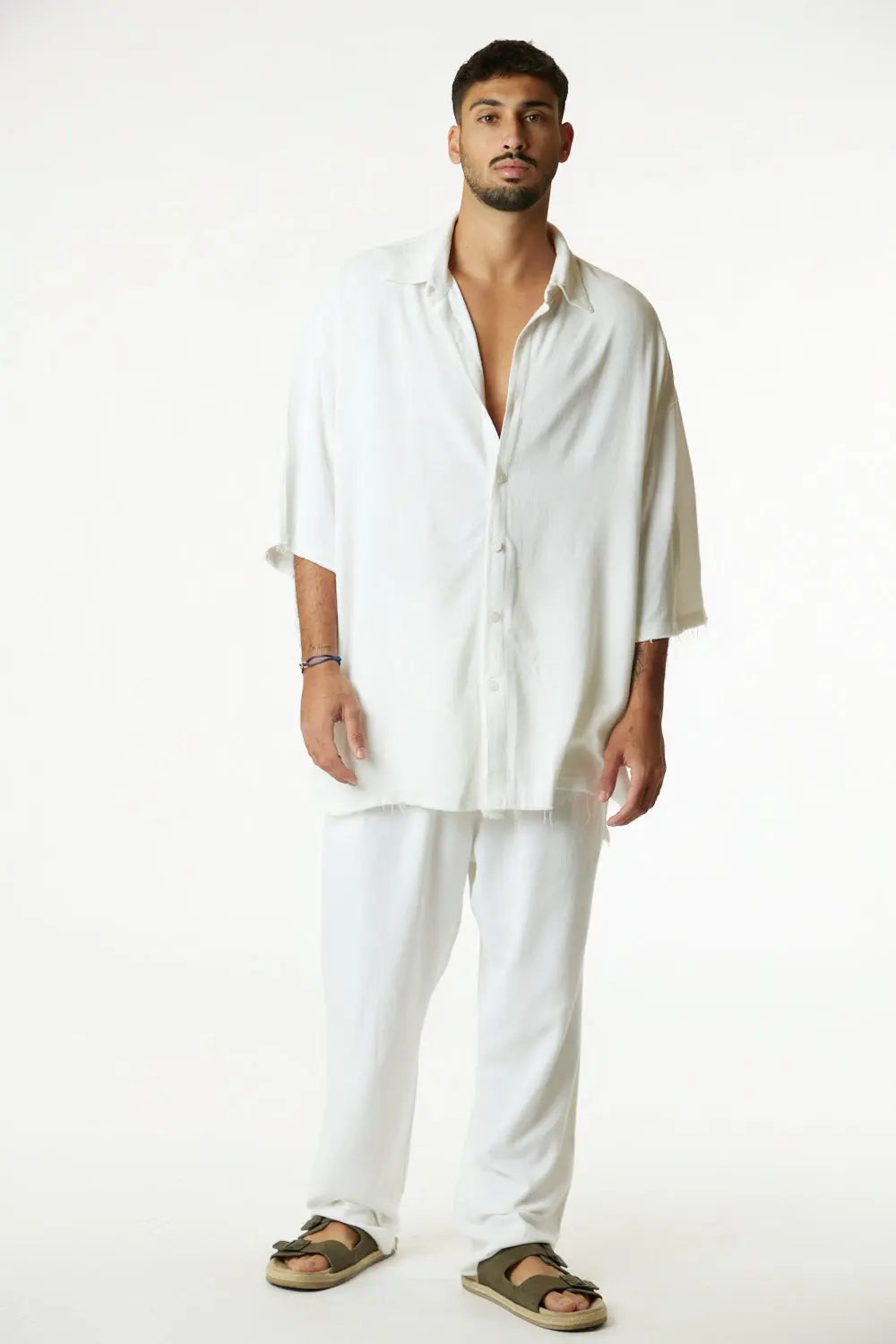 Man wearing a cream Soft Linen Short Sleeve Button-Up Shirt and matching cream pants