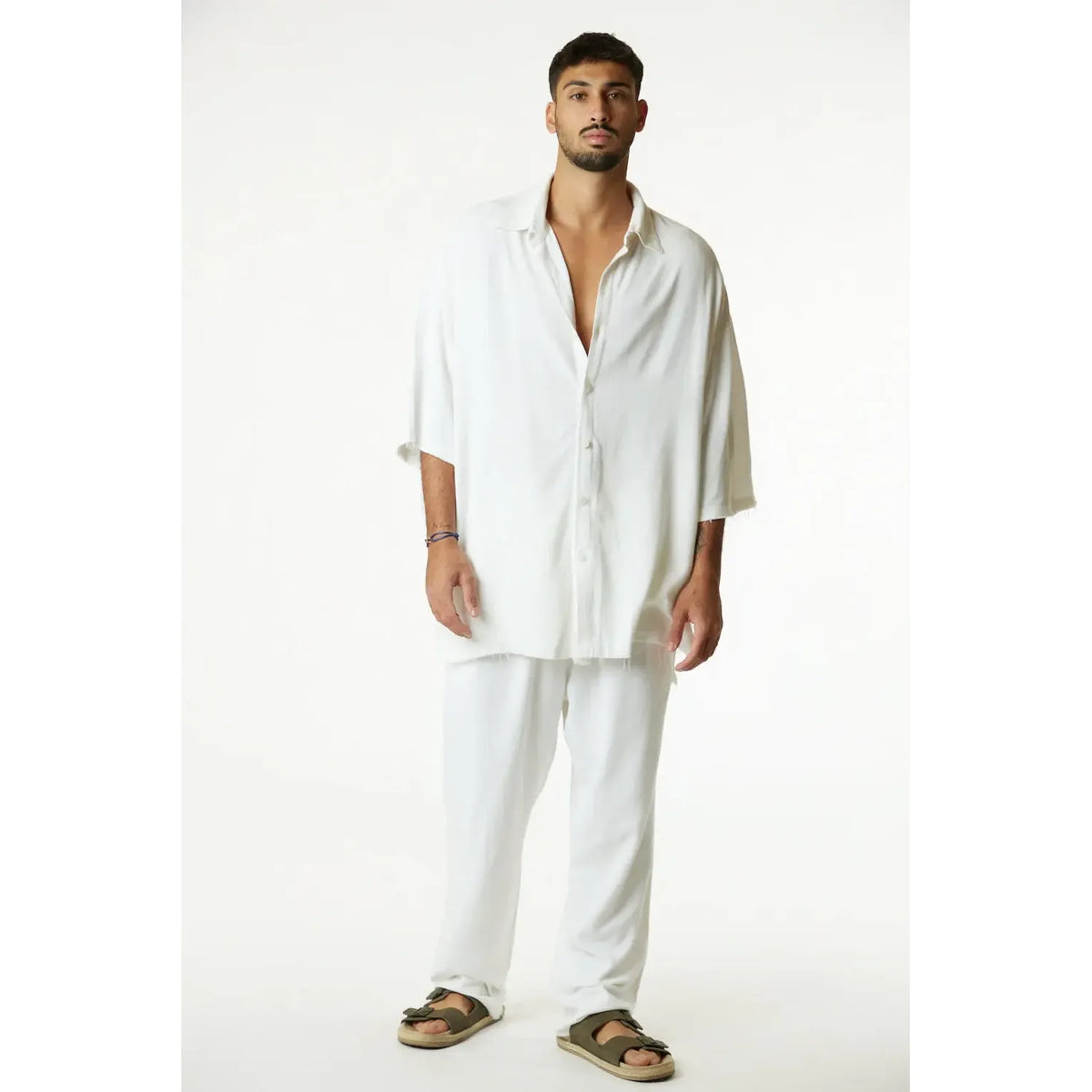 Man wearing a cream Soft Linen Short Sleeve Button-Up Shirt and matching cream pants
