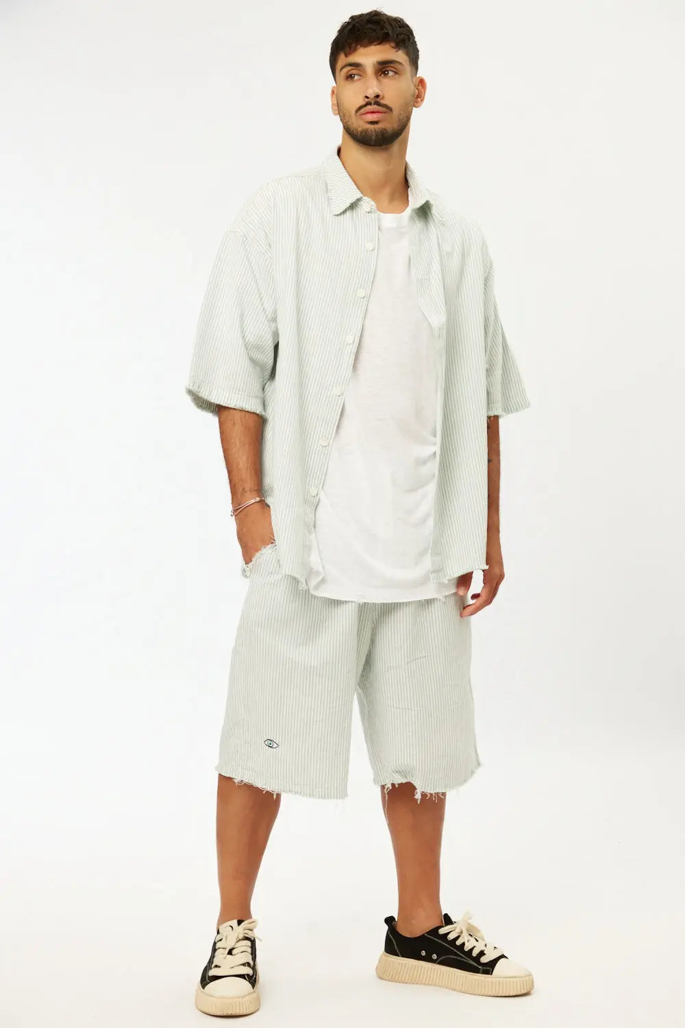 Man wearing Striped Green Linen Set with short sleeve shirt and Bermuda shorts