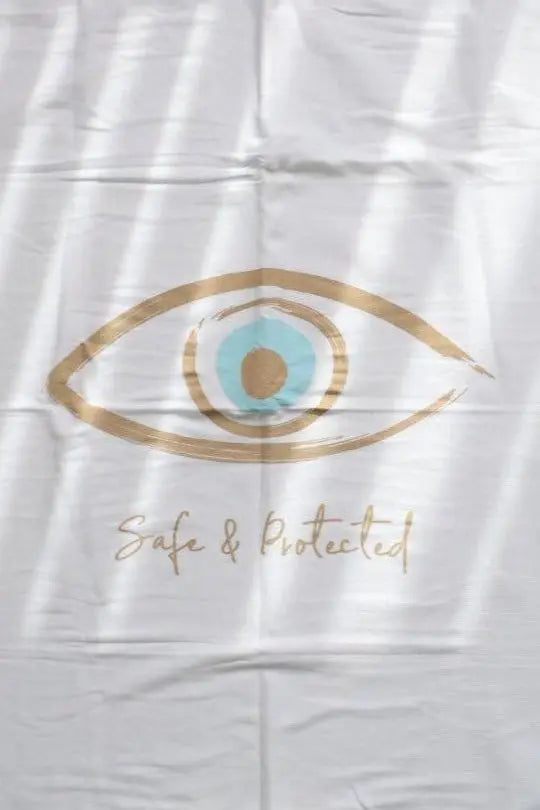 Cotton Single Elliptical Eye Blanket with a large gold and blue eye design and the words Safe & Protected