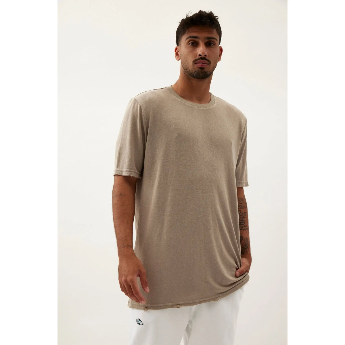 Nicki Soft Open Top in light olive green on a male model with a hand in his pocket