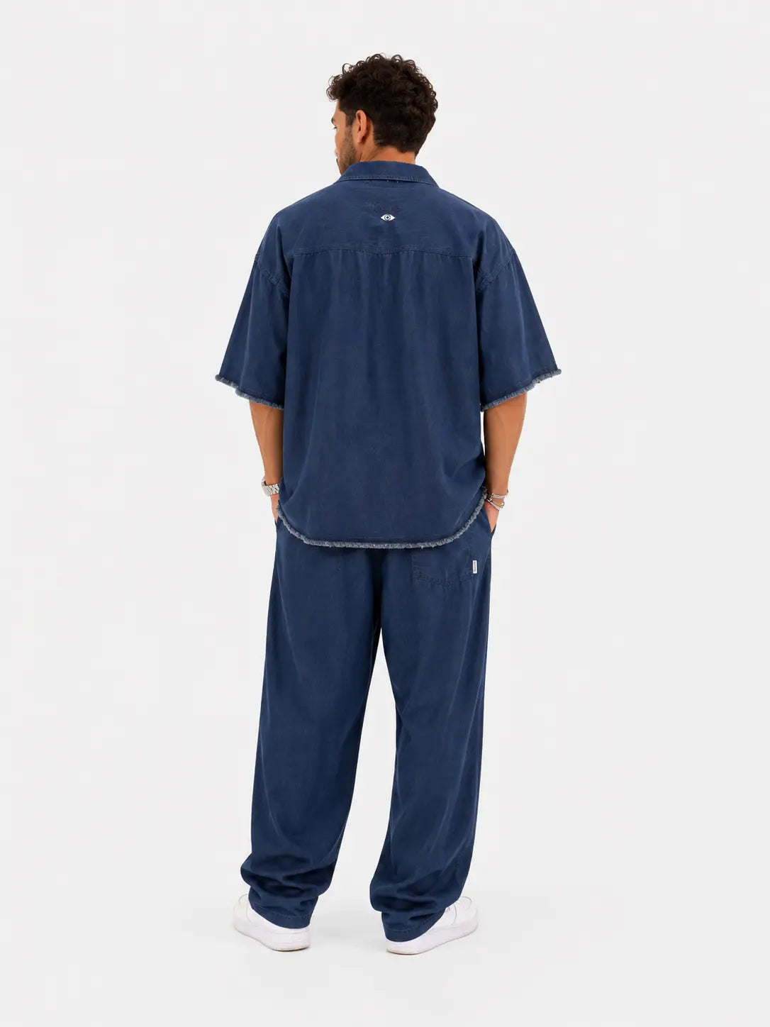Man wearing TFU Oversized Denim Pants and matching short-sleeved shirt, seen from behind