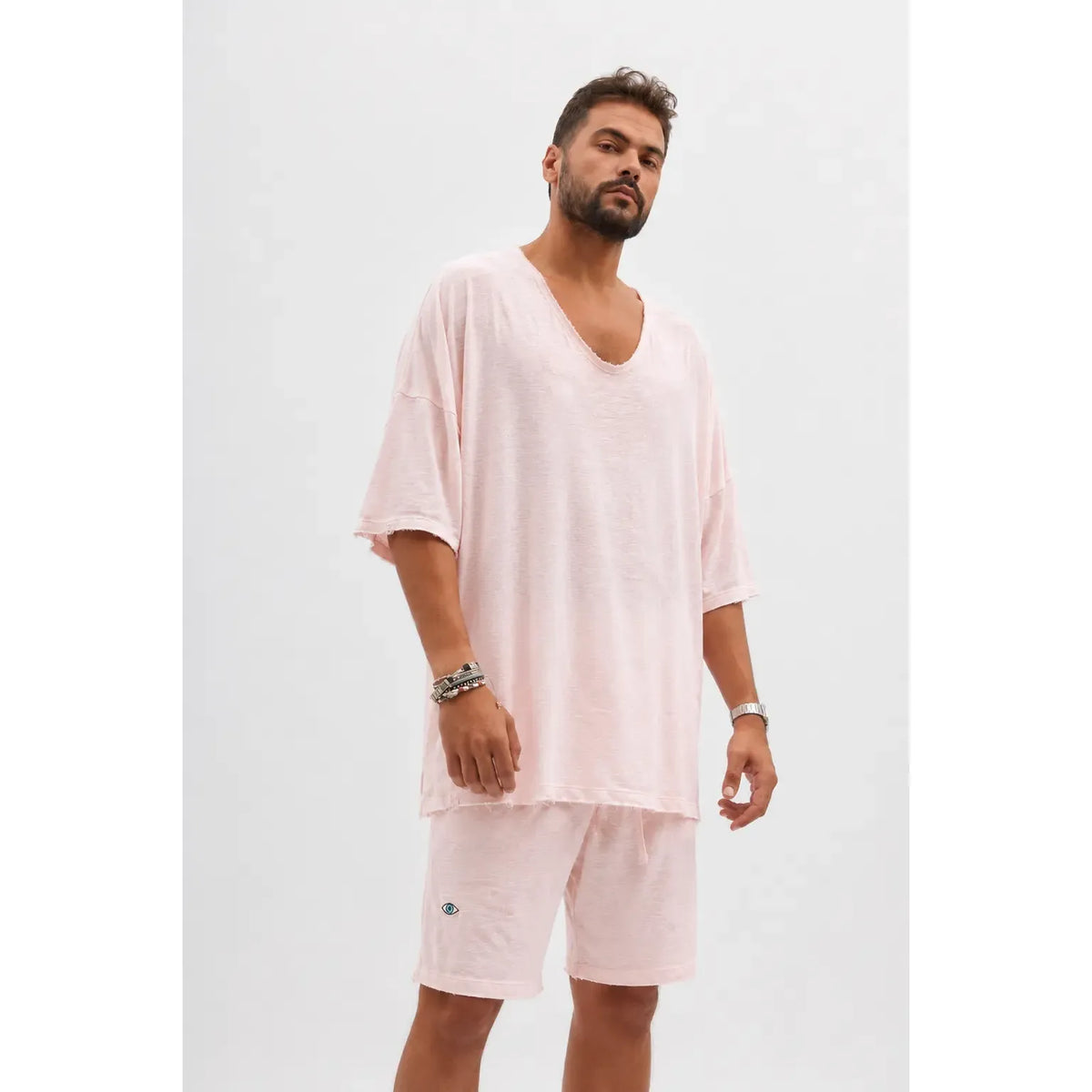 Dor Oversized Shirt in baby pink worn by a man with a beard, paired with matching shorts