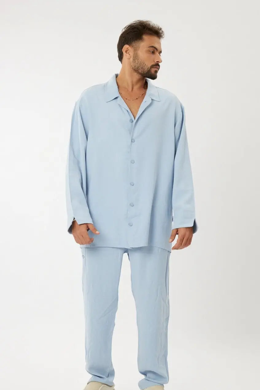 Man wearing a light blue Lux Set, including a button-up shirt and matching pants