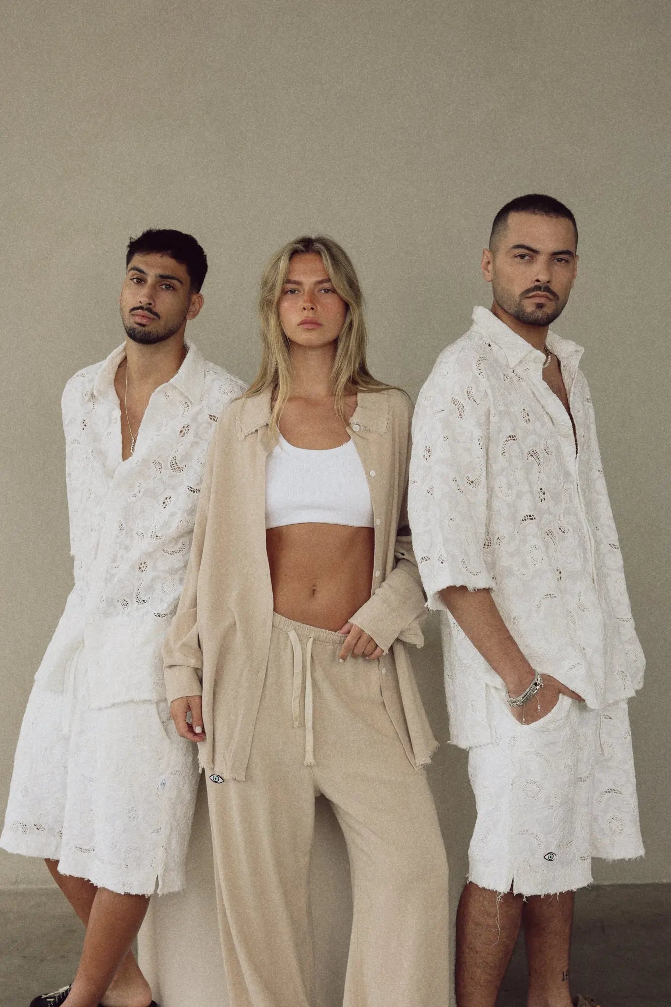 Three models wearing FLR WHITE LIMITED EDITION Jacket and matching shorts and pants
