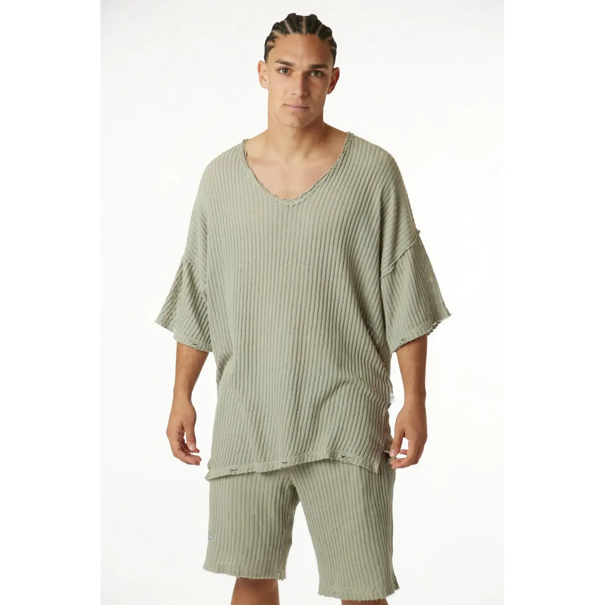Man wearing khaki striped knit pants and matching top