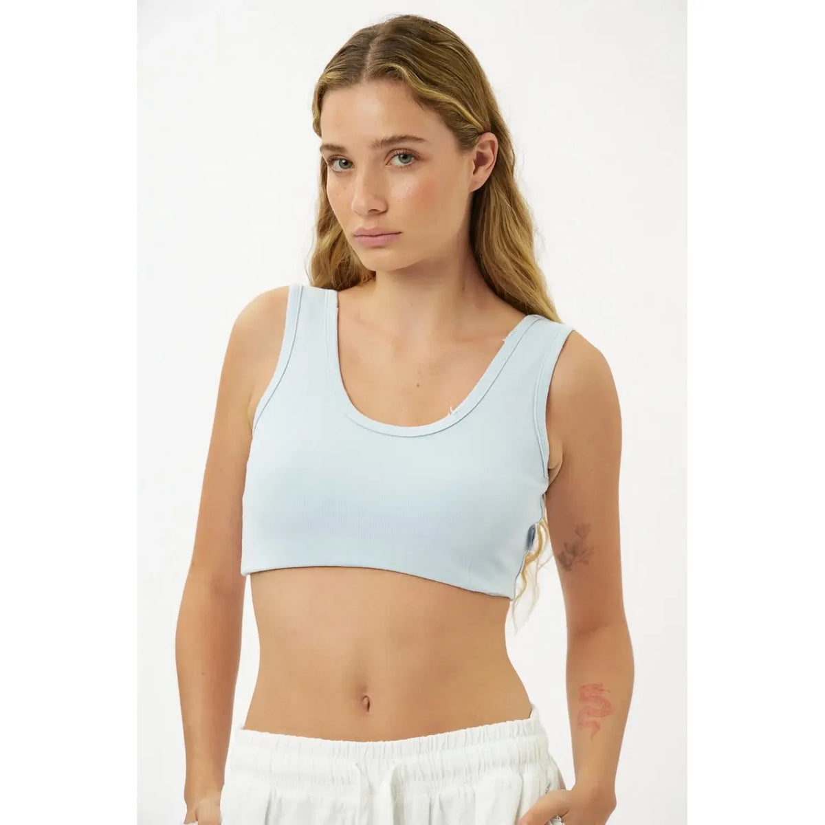 Essential Crop Top in light blue worn by a woman with long blonde hair