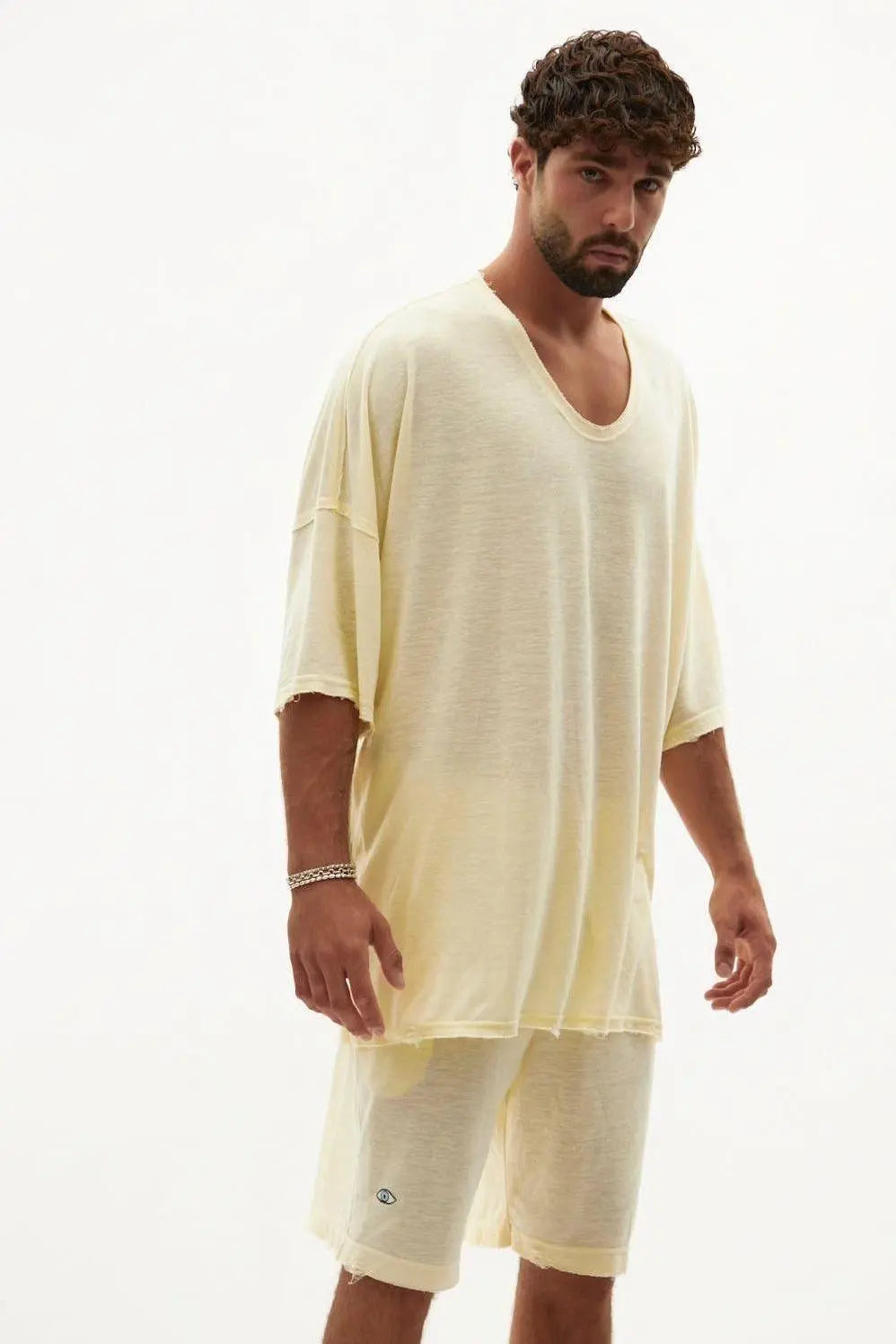 Man wearing a banana colored basic set with an oversized t-shirt and shorts