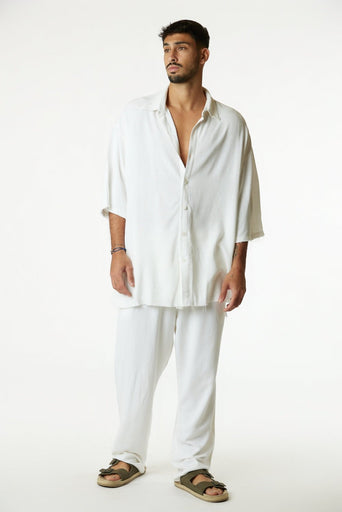 Man wearing a white shirt and pants on a white background