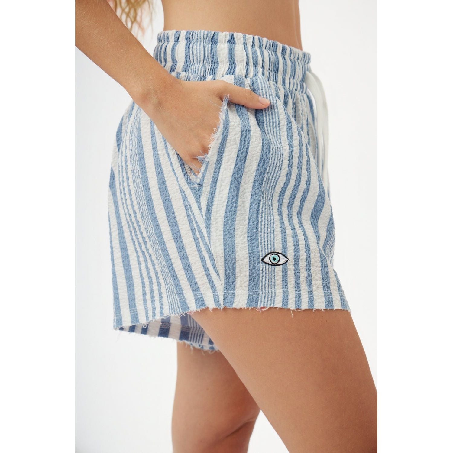 Blue and white striped shorts with a visible brand logo on a neutral background