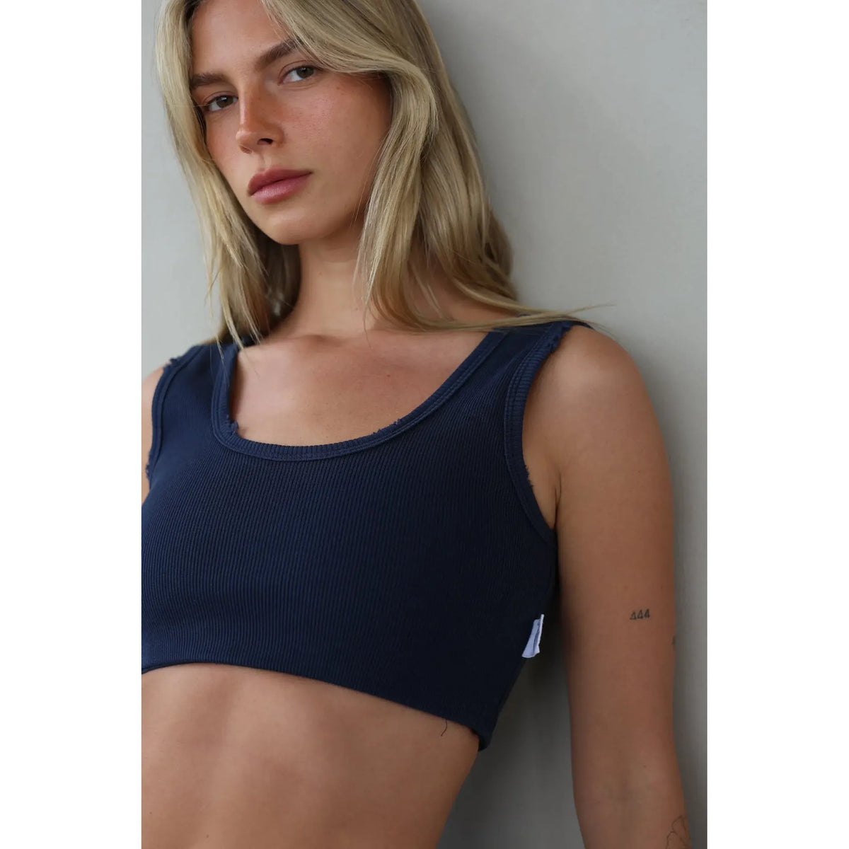 Essential Crop Top in navy blue on a model with blonde hair